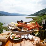 1050478 – Seafood platter with loch in background