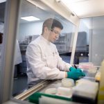 CPI researcher preparing to collect fish feed cultures